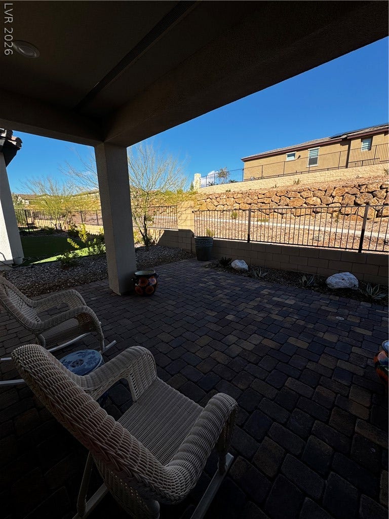 162 Palm Fox Court, Henderson, NV 89011 A private paved courtyard provides a serene outdoor retreat under clear blue skies.