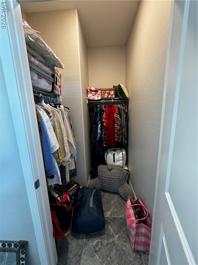 162 Palm Fox Court, Henderson, NV 89011 A spacious walk-in closet features built-in wire shelving and durable stone tile flooring.