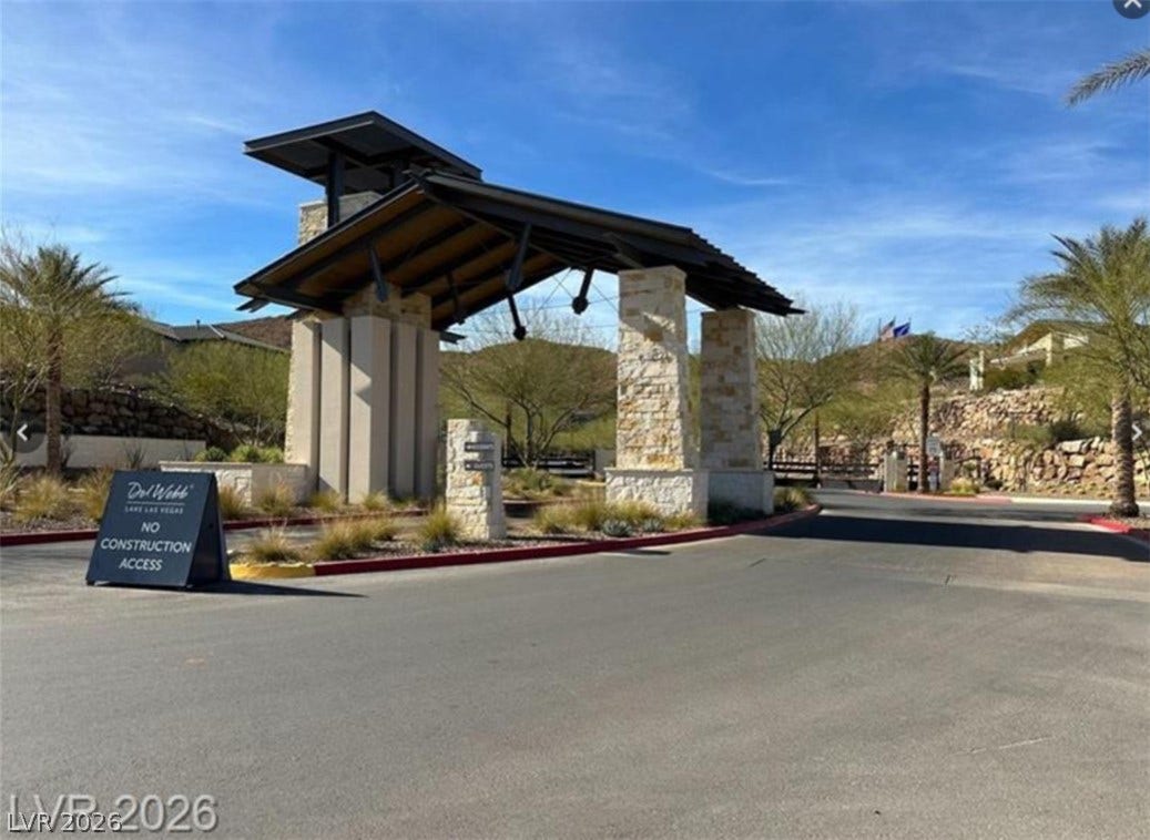 162 Palm Fox Court, Henderson, NV 89011 An architectural gatehouse entrance Welcomes residents with stone pillars and timber framing.
