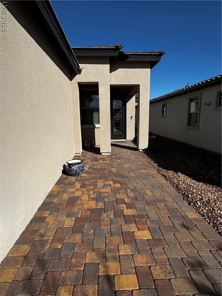 162 Palm Fox Court, Henderson, NV 89011 A beautifully paved walkway guides the way to a private covered entrance.