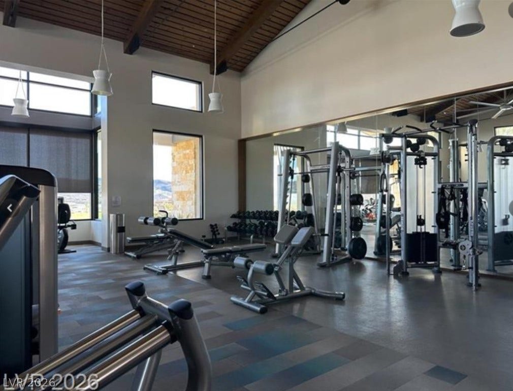 162 Palm Fox Court, Henderson, NV 89011 Towering beamed wood ceilings highlight this professional exercise space with expansive mirrored walls.