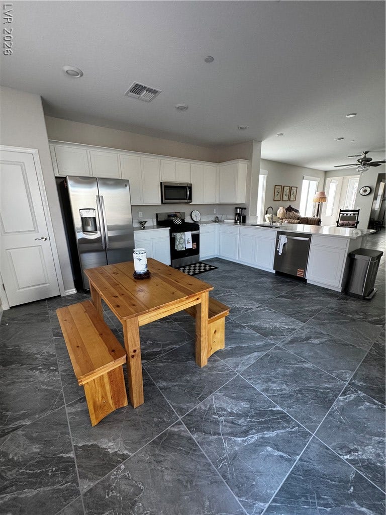 162 Palm Fox Court, Henderson, NV 89011 Gleaming stone tile floors anchor this modern cooking space outfitted with recessed lighting.