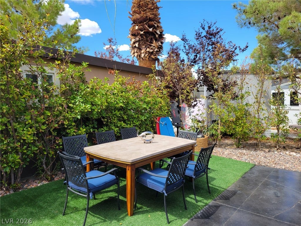 8175 Arville Street, #293, Las Vegas, NV 89139 Mature trees and lush green hedges create a private outdoor dining retreat.