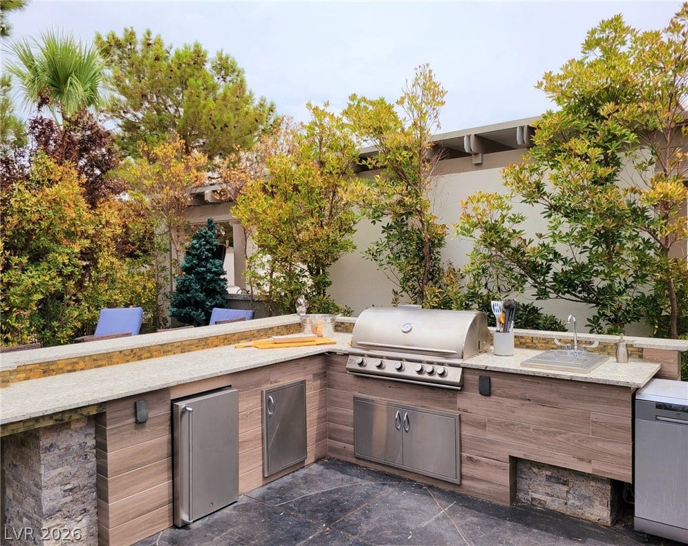 8175 Arville Street, #293, Las Vegas, NV 89139 An outdoor kitchen features durable stone counters and a built-in stainless steel grill.