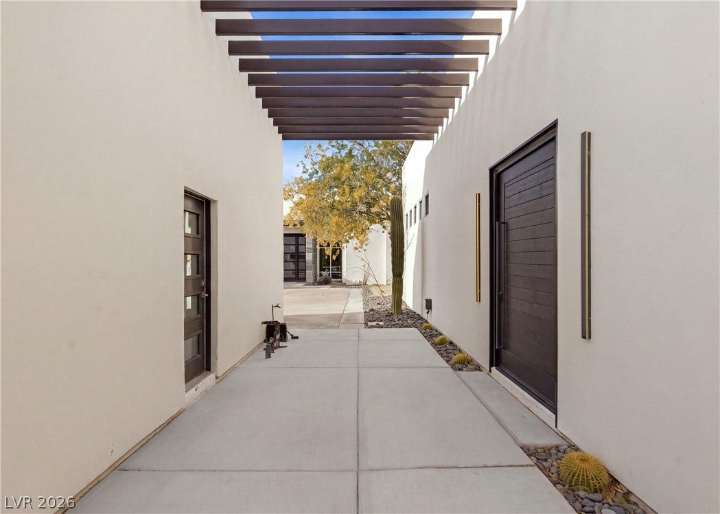 3716 Caesars Circle, Las Vegas, NV 89120 An inviting entry pathway features concrete pavers under a stylish modern pergola.