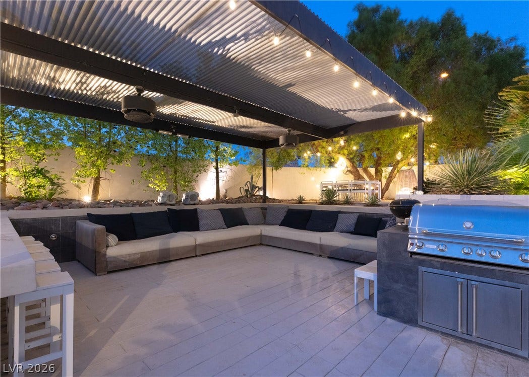 3716 Caesars Circle, Las Vegas, NV 89120 An inviting outdoor kitchen and sheltered lounge space perfect for evening entertaining.
