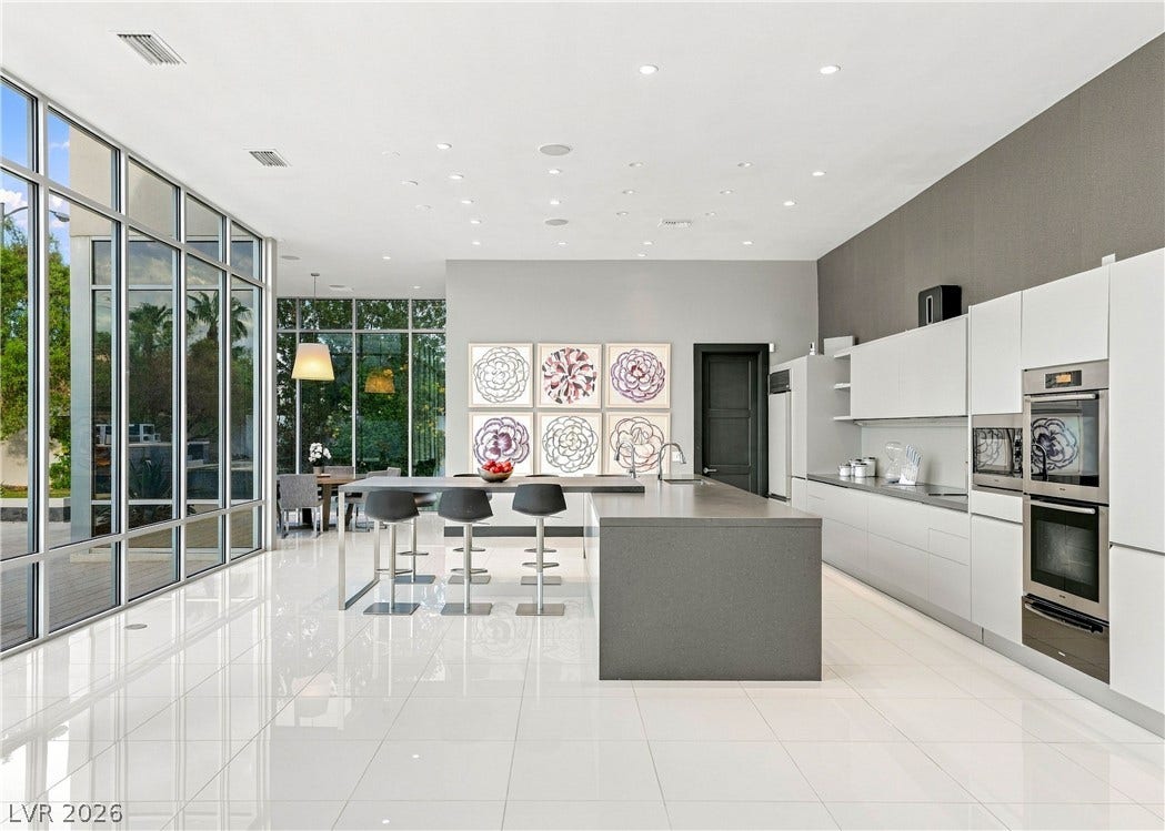 3716 Caesars Circle, Las Vegas, NV 89120 Floor-to-ceiling windows flood this modern culinary space and sleek breakfast bar with light.