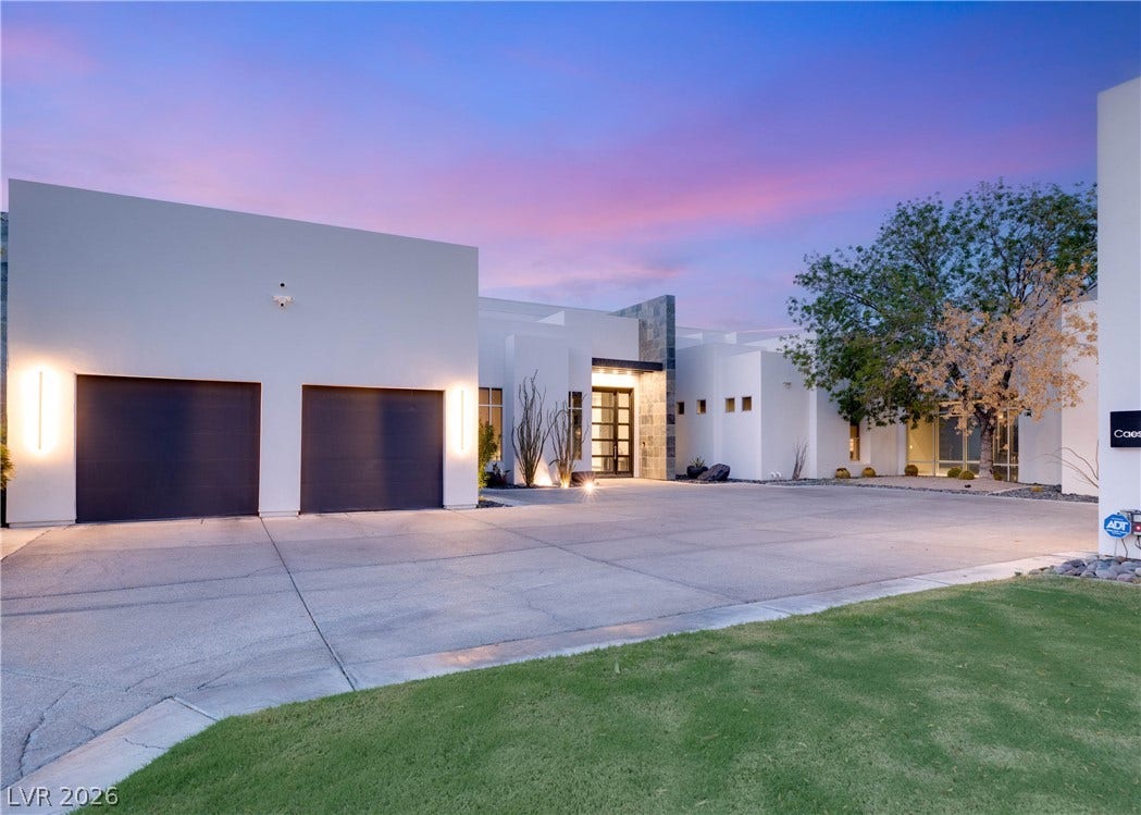 3716 Caesars Circle, Las Vegas, NV 89120 Sleek contemporary architecture defines this striking desert residence featuring a spacious multi-car garage.