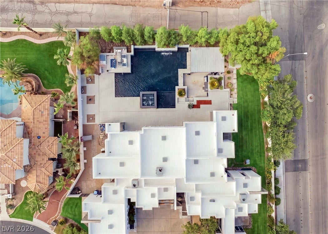 3716 Caesars Circle, Las Vegas, NV 89120 An aerial perspective showcases the geometric modern architecture and private backyard oasis with swimming pool.