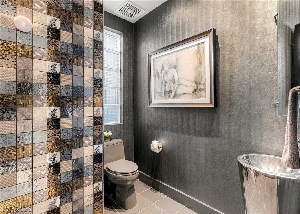 3716 Caesars Circle, Las Vegas, NV 89120 Textured walls and intricate mosaic tiling define this unique powder room.