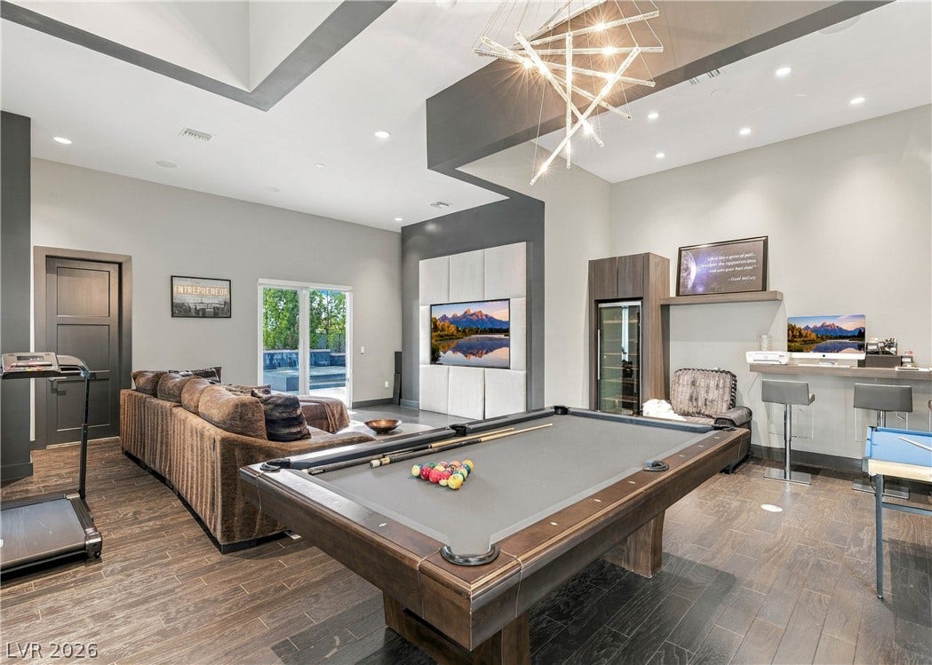 3716 Caesars Circle, Las Vegas, NV 89120 Rich hardwood flooring and architectural tray ceilings define this versatile recreational space.