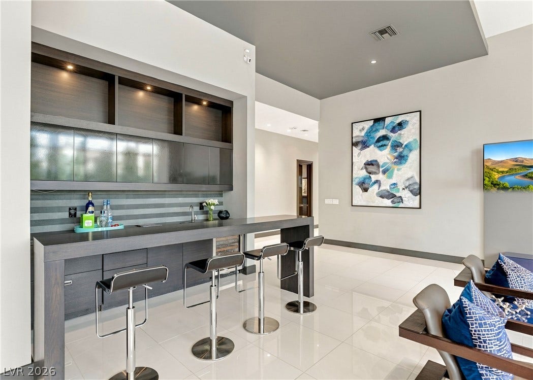 3716 Caesars Circle, Las Vegas, NV 89120 Polished tile flooring and sleek modern cabinetry anchor this contemporary built-in wet bar setup.
