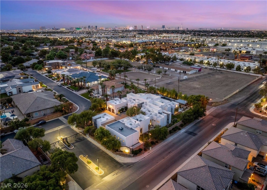 3716 Caesars Circle, Las Vegas, NV 89120 Dusk skies frame this contemporary estate showcasing flat rooflines and a secure gated entrance.