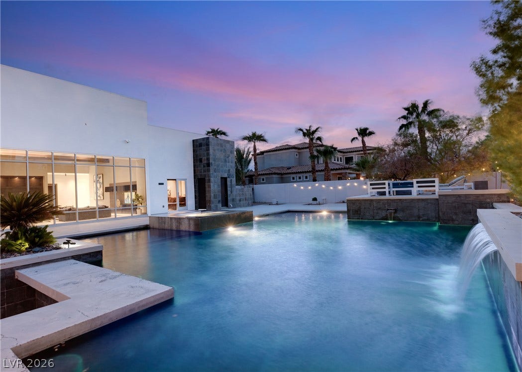 3716 Caesars Circle, Las Vegas, NV 89120 A resort-style swimming pool with cascading water features complements the modern architectural facade.