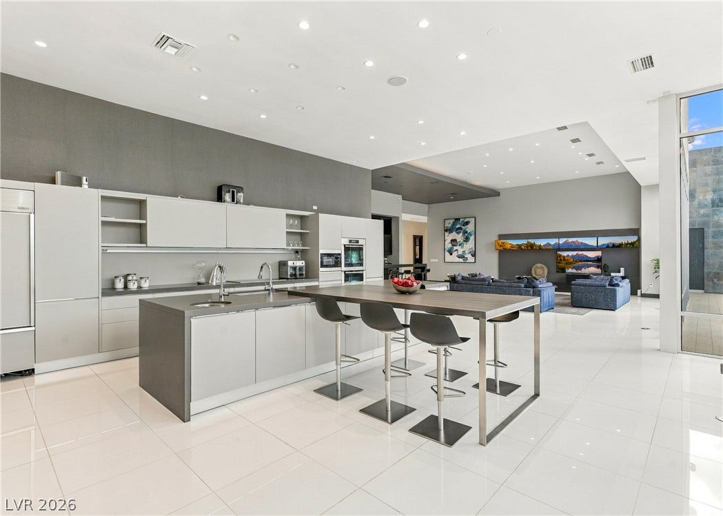 3716 Caesars Circle, Las Vegas, NV 89120 Gleaming tile floors and high ceilings define this expansive open-concept gourmet kitchen.
