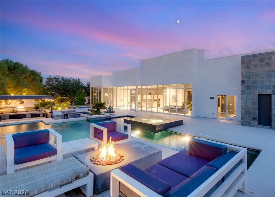 3716 Caesars Circle, Las Vegas, NV 89120 A resort-style backyard oasis features clean architectural lines alongside an integrated pool and fire pit.