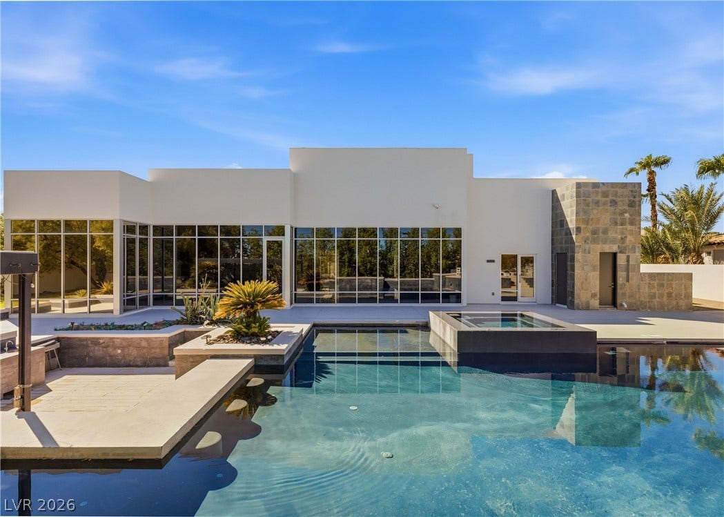 3716 Caesars Circle, Las Vegas, NV 89120 Sleek contemporary architecture frames a gleaming pool and spa under wide desert skies.
