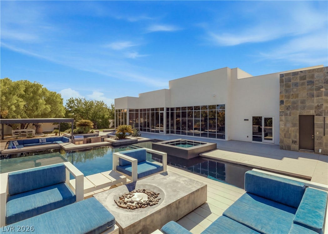 3716 Caesars Circle, Las Vegas, NV 89120 Geometric modern architecture frames a massive custom swimming pool under wide blue skies.