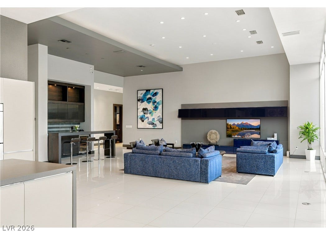 3716 Caesars Circle, Las Vegas, NV 89120 Polished tile flooring and recessed lighting define this spacious, modern open-concept living area.