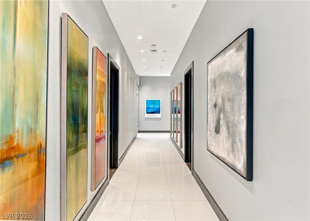 3716 Caesars Circle, Las Vegas, NV 89120 Polished tile flooring and recessed lighting define this gallery-style hallway.