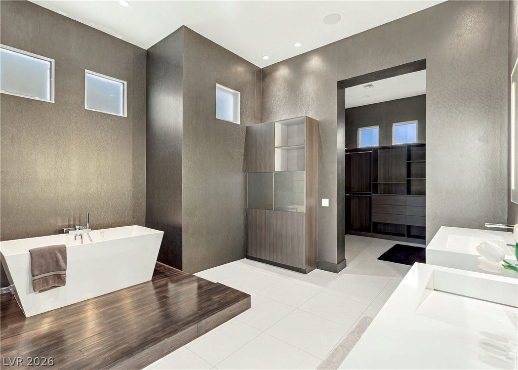 3716 Caesars Circle, Las Vegas, NV 89120 Clean lines and a freestanding tub define this contemporary primary bath sanctuary.