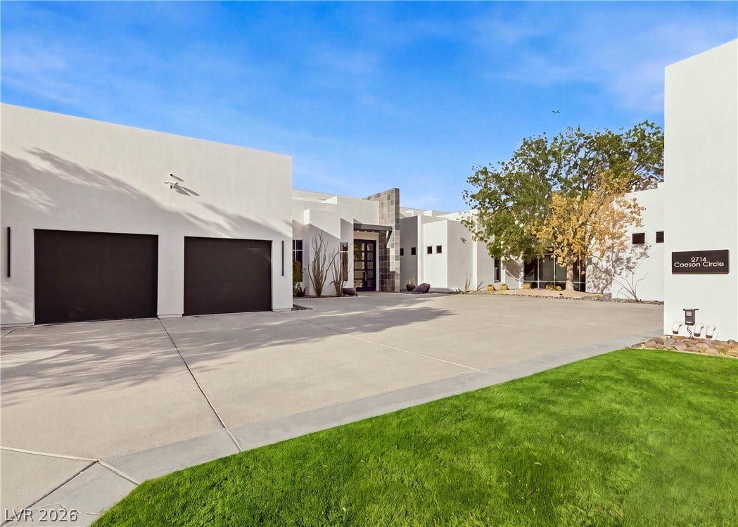 3716 Caesars Circle, Las Vegas, NV 89120 Striking contemporary architecture pairs with a spacious concrete driveway and manicured lawn.