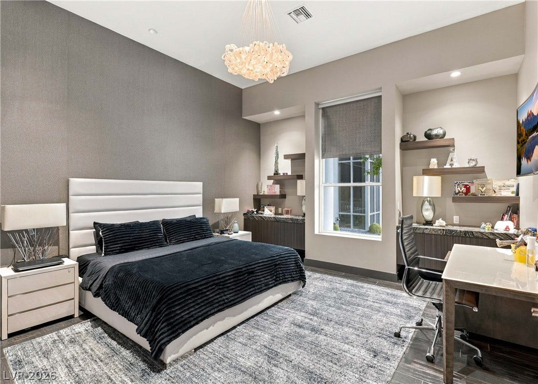 3716 Caesars Circle, Las Vegas, NV 89120 A spacious bedroom offers soaring ceilings alongside built-in shelves and integrated study spaces.