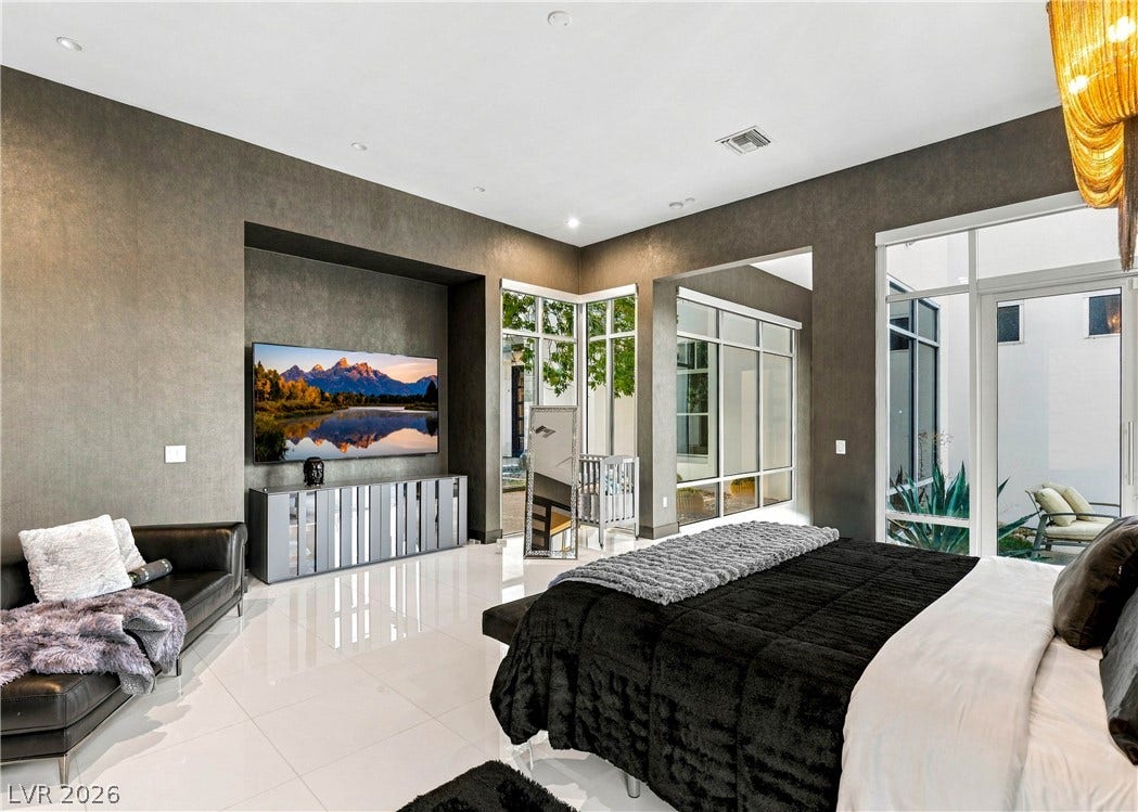 3716 Caesars Circle, Las Vegas, NV 89120 Polished tile flooring and textured walls define this modern bedroom layout with patio access.