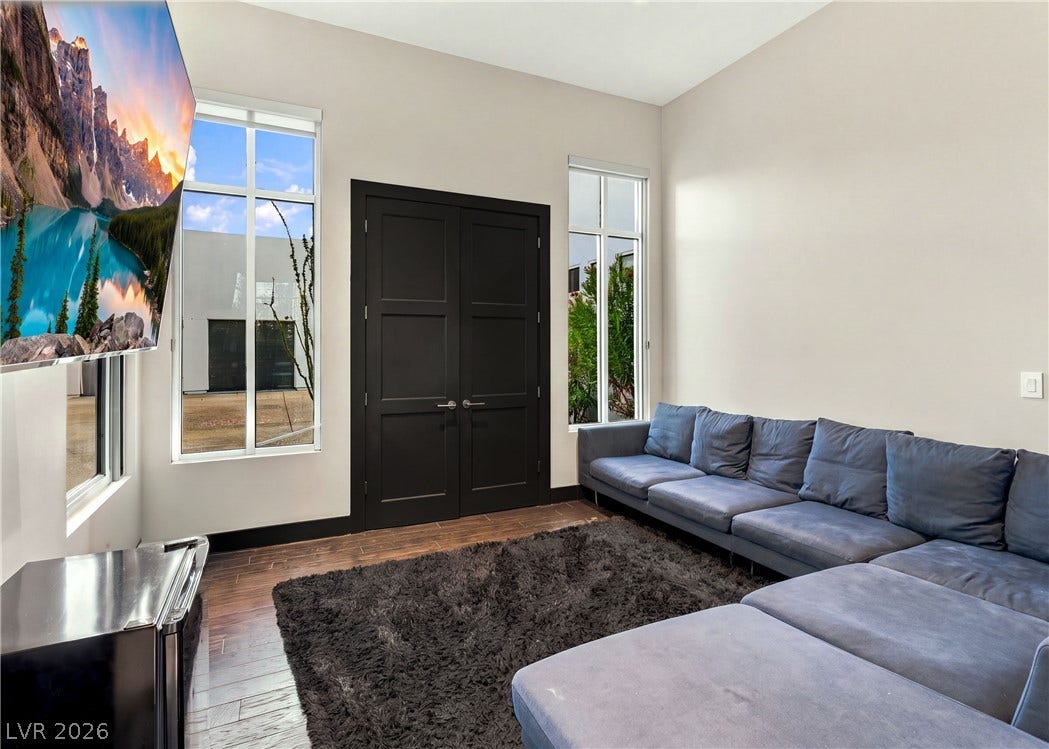 3716 Caesars Circle, Las Vegas, NV 89120 Gleaming hardwood floors and towering windows define this airy, modern living space.