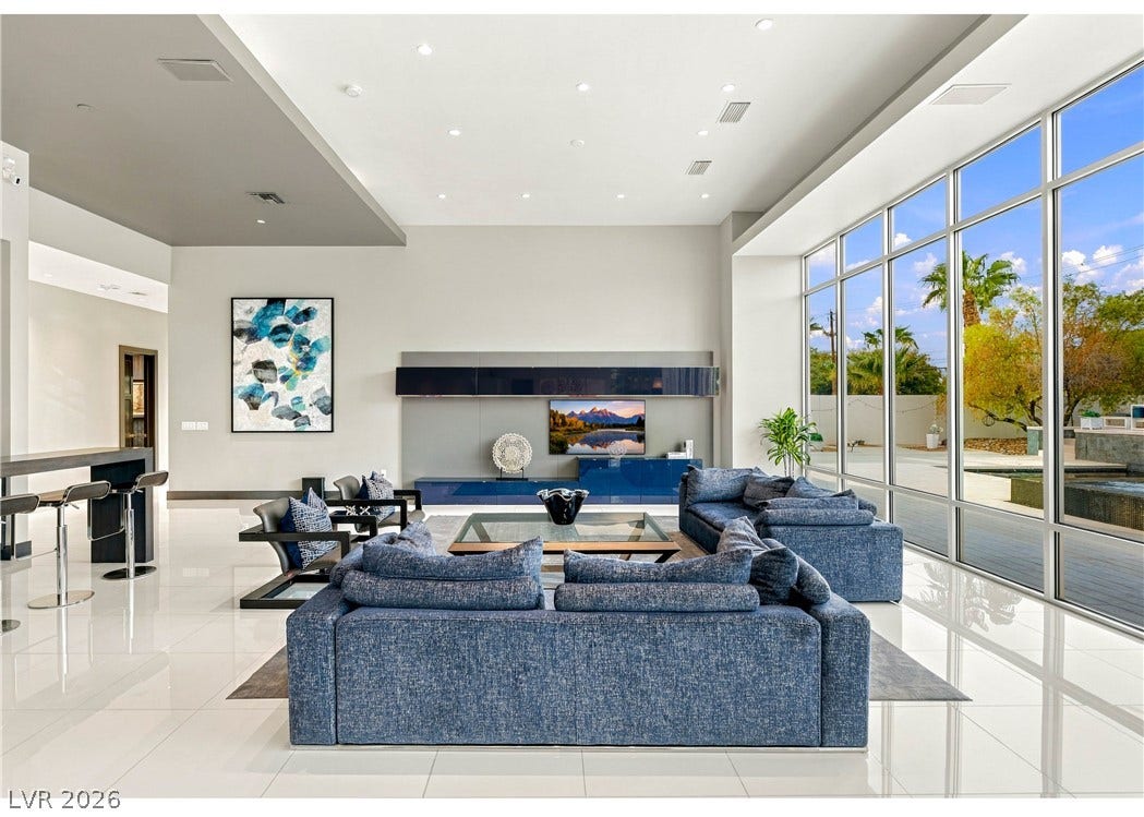 3716 Caesars Circle, Las Vegas, NV 89120 Floor-to-ceiling windows bathe this modern living area in natural light.