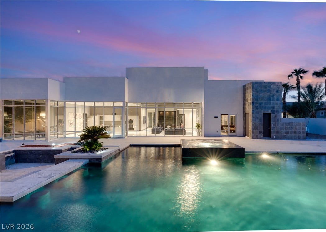 3716 Caesars Circle, Las Vegas, NV 89120 Geometric modern architecture frames a luminous pool terrace beneath a twilight sky.