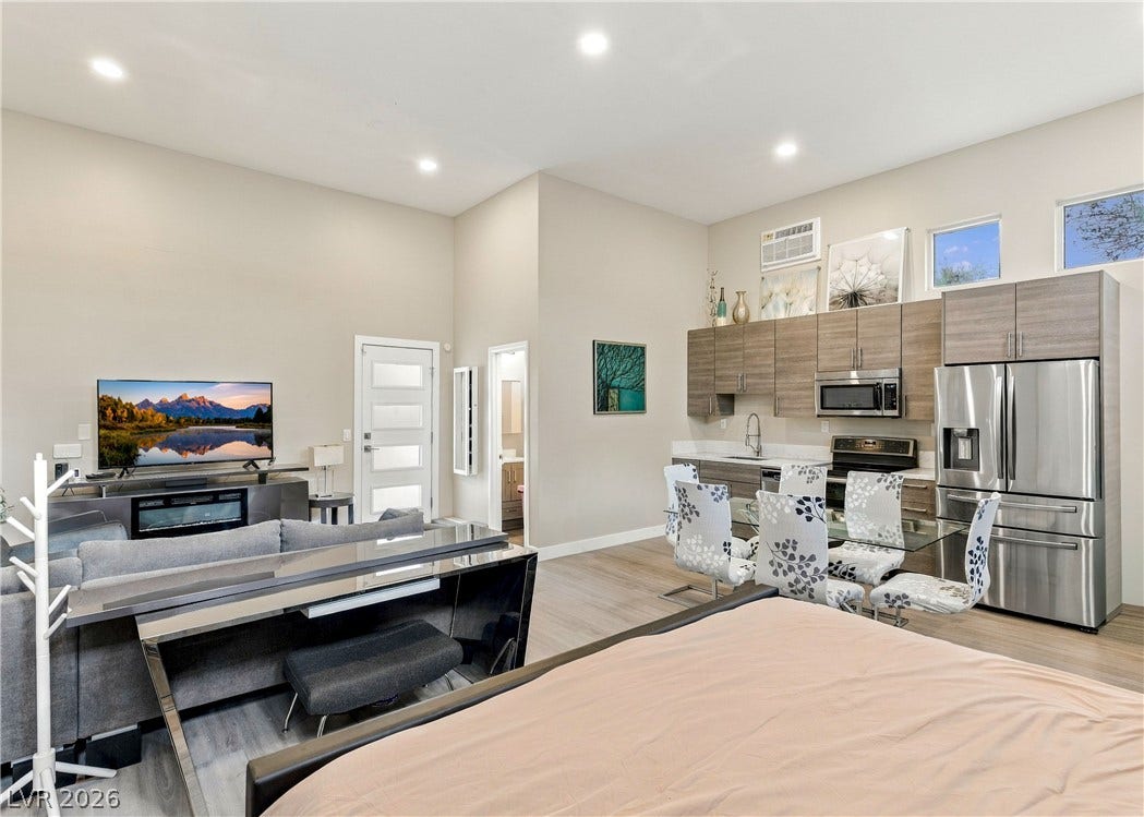 3716 Caesars Circle, Las Vegas, NV 89120 High ceilings and wood-look flooring enhance this modern, open-concept living space and kitchen.