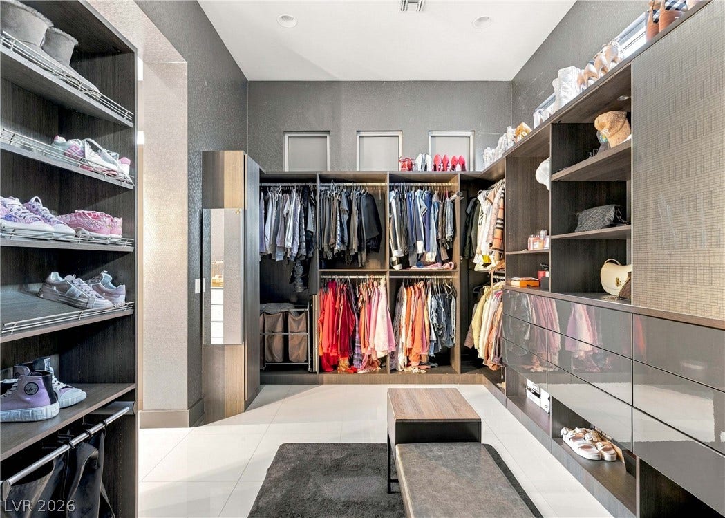 3716 Caesars Circle, Las Vegas, NV 89120 Sleek custom cabinetry and recessed lighting define this expansive wardrobe space.