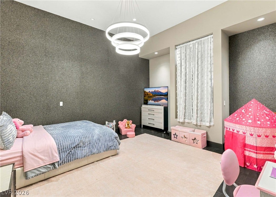 3716 Caesars Circle, Las Vegas, NV 89120 Gleaming wood floors and a contemporary light fixture define this airy bedroom space.