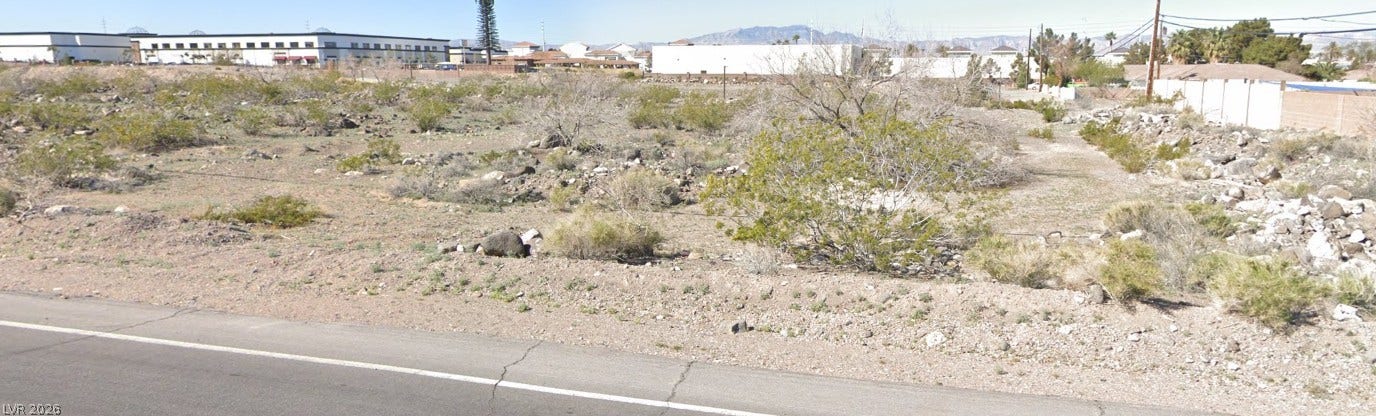 Goldhill Road, Henderson, NV 89123 An open desert lot bordered by paved roads offers mountain views in the distance.