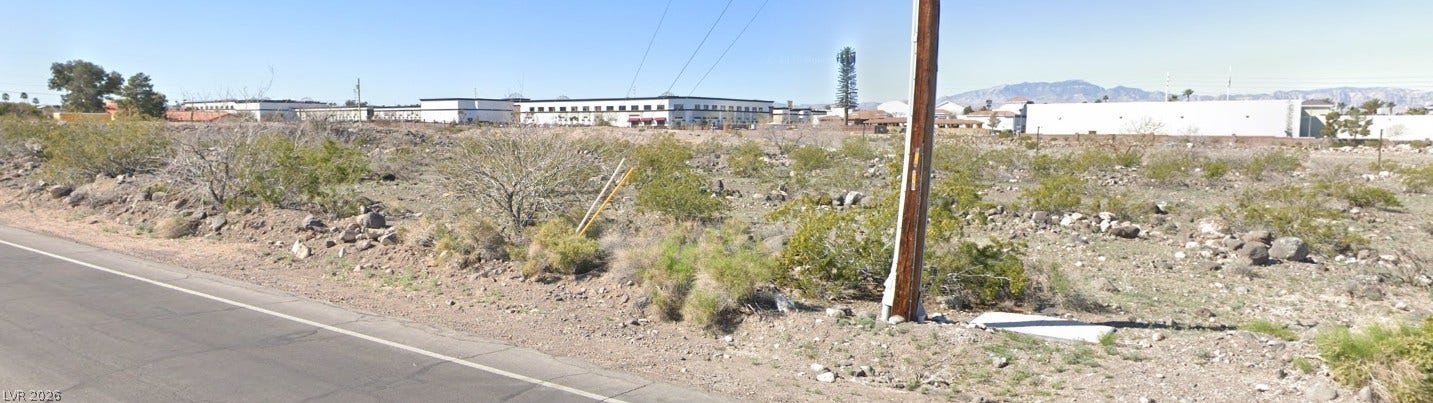 Goldhill Road, Henderson, NV 89123 Distant mountain views frame this expansive desert lot bordered by paved road access.