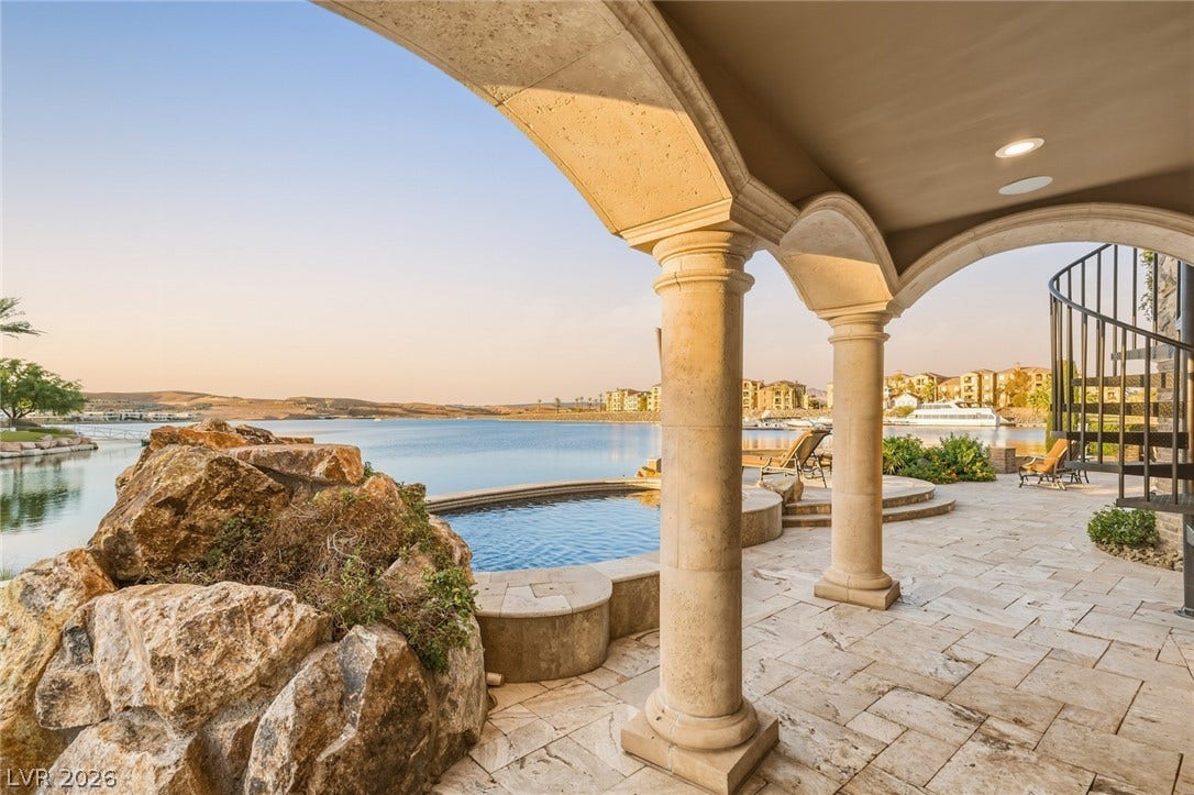 7 Lido Nord, Henderson, NV 89011 Stone columns frame beautiful lake views from this covered patio with tile flooring.