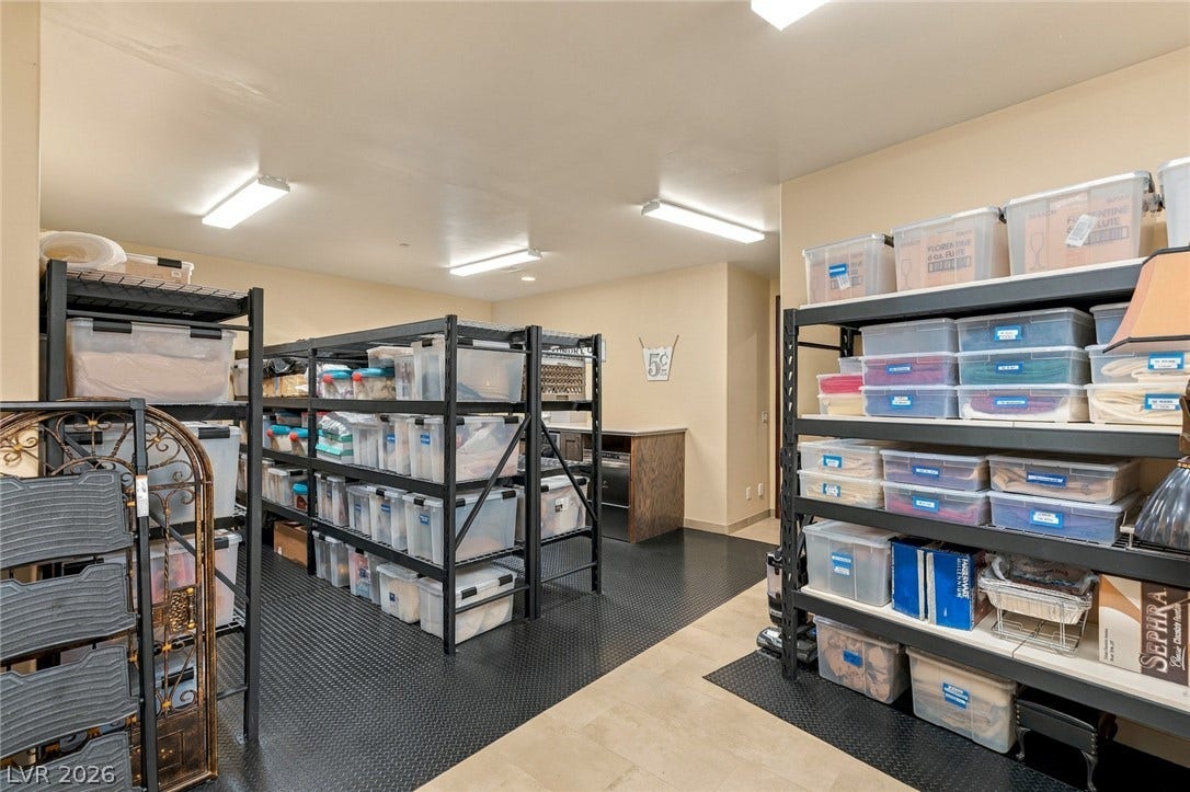 7 Lido Nord, Henderson, NV 89011 A spacious organized storage room featuring durable textured flooring and ample built-in shelving.