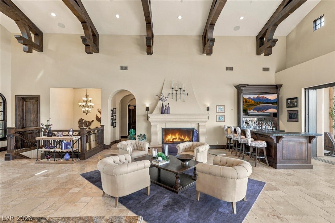 7 Lido Nord, Henderson, NV 89011 Massive exposed beams crown this open living space featuring tile flooring and a central fireplace.