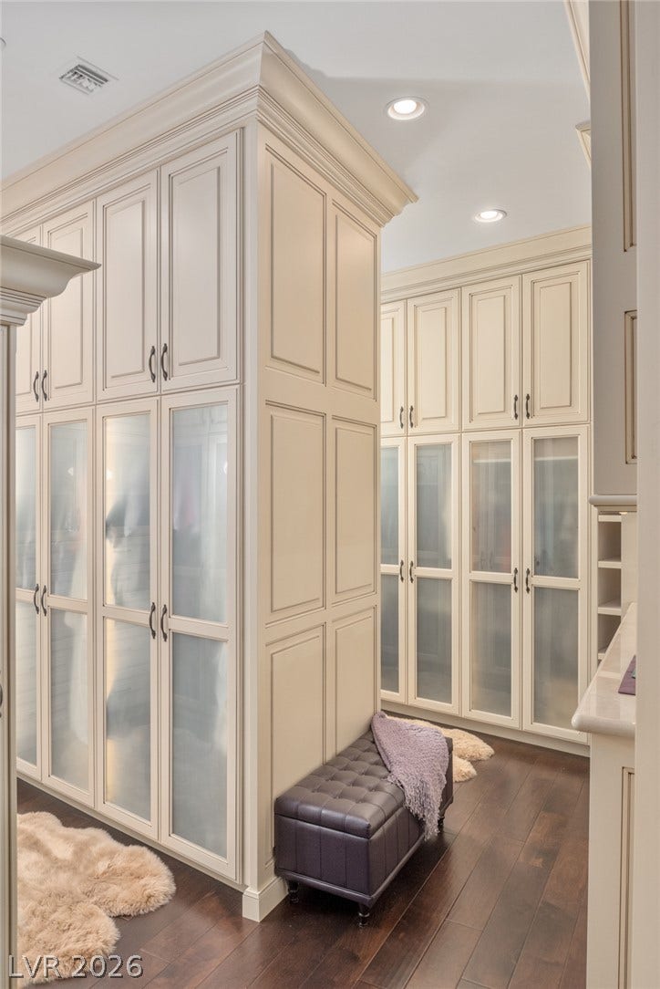 7 Lido Nord, Henderson, NV 89011 Floor-to-ceiling custom cabinetry with frosted glass panels lines this elegant walk-in closet.