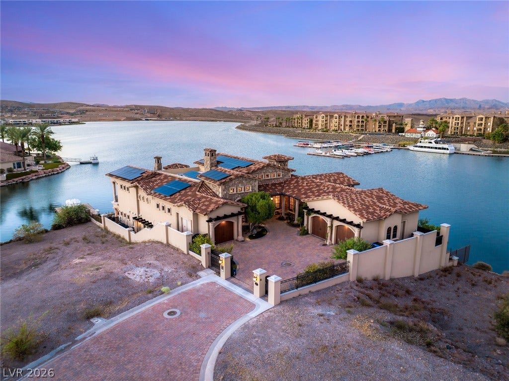 7 Lido Nord, Henderson, NV 89011 An aerial perspective showcases the stone-accented exterior and clay tile roof along the water.