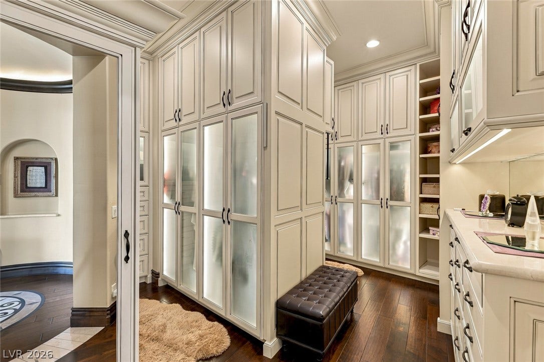 7 Lido Nord, Henderson, NV 89011 Floor-to-ceiling built-ins and rich wood flooring elevate this spacious dressing area.