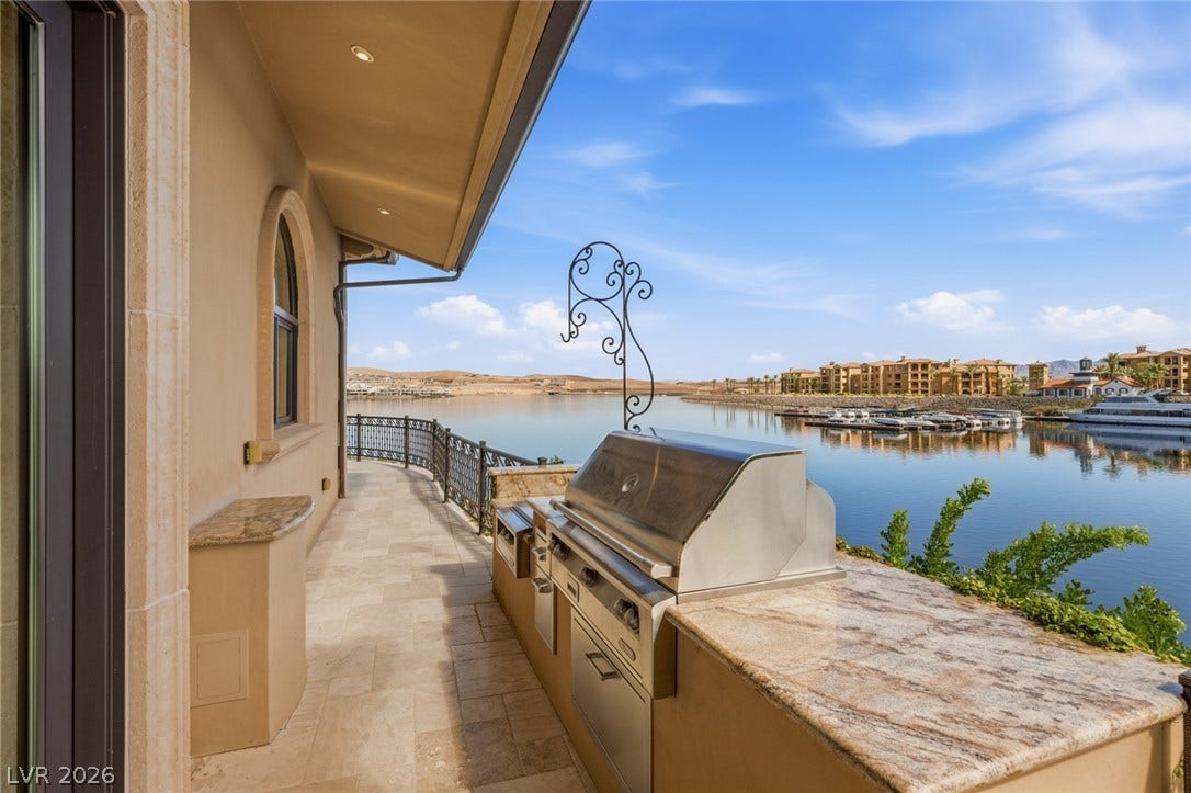 7 Lido Nord, Henderson, NV 89011 A stone-paved balcony showcases a built-in outdoor kitchen with sweeping harbor views.