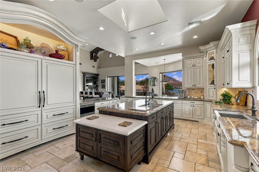 7 Lido Nord, Henderson, NV 89011 Ornate cabinetry and a multi-level island anchor this gourmet space beneath a bright skylight.