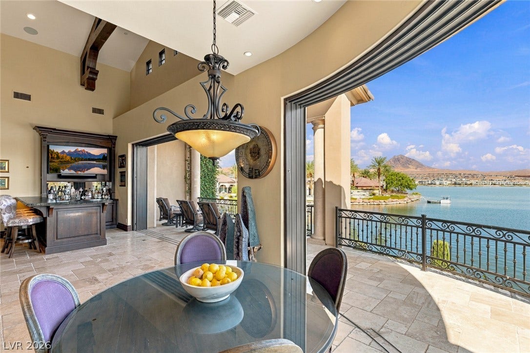 7 Lido Nord, Henderson, NV 89011 Retractable glass doors frame scenic water views from the tiled dining area and bar.