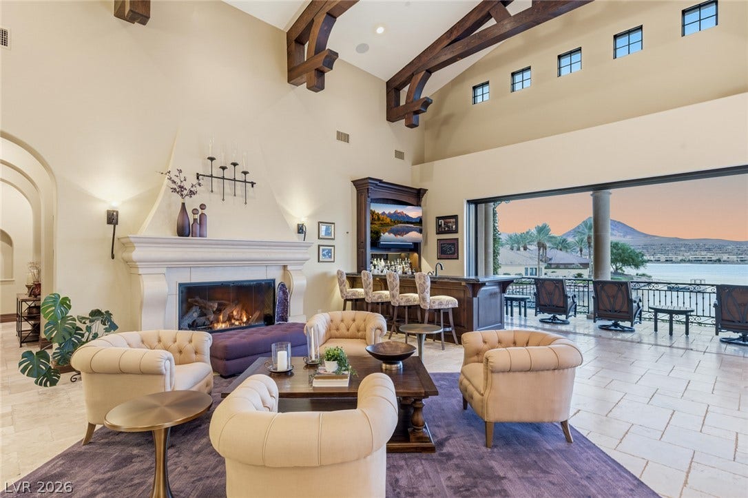 7 Lido Nord, Henderson, NV 89011 Towering beamed ceilings and a grand fireplace anchor this expansive lakeside living space.