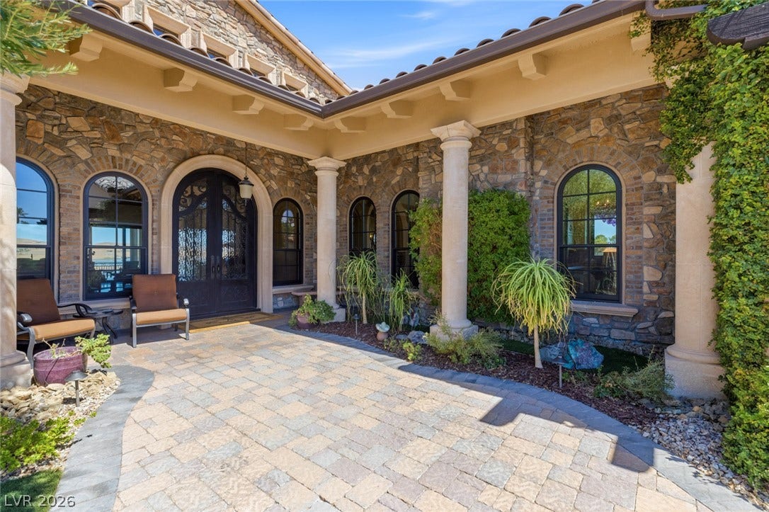 7 Lido Nord, Henderson, NV 89011 Stone walls and classical columns frame this inviting entry courtyard paved with stone.