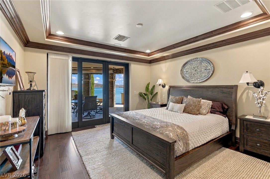 7 Lido Nord, Henderson, NV 89011 Rich hardwood flooring complements a detailed tray ceiling, with sliding doors opening to lake views.