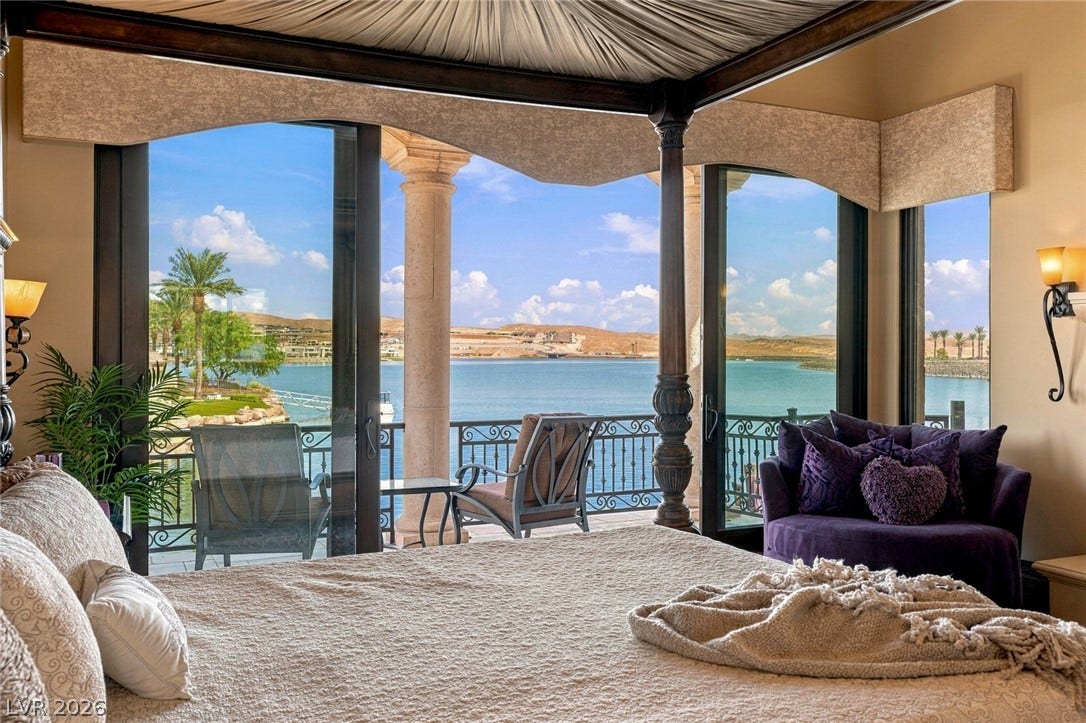 7 Lido Nord, Henderson, NV 89011 Glazing walls frame picturesque lake views directly from this elegant bedroom suite.