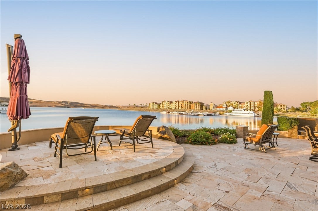 7 Lido Nord, Henderson, NV 89011 Multi-level stone patio offers peaceful waterfront views over calm harbor waters.